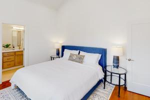 a bedroom with a white bed and a blue headboard at Leisure Lodge Living in Gunnison