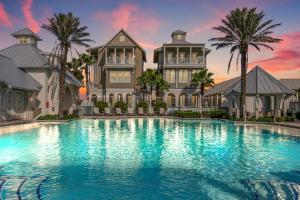 a mansion with a large swimming pool in front of it at Spanish Dagger Serenity in Port Aransas