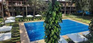 a swimming pool in front of a hotel at Kabira Country Club in Kampala