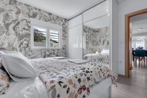 a bedroom with a bed and a mirror at Apartman GLOW in Makarska