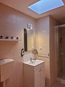 a bathroom with a sink and a mirror at Alta apartments in Coimbra
