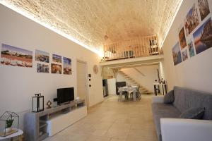a living room with a couch and a television at La Casetta in Mola di Bari