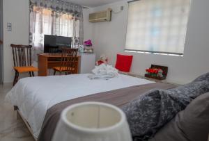 a bedroom with a bed and a desk with a computer at GOLDEN MOON in Aiándion