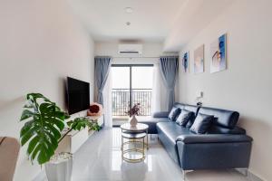 ein Wohnzimmer mit einem blauen Sofa und einem Fenster in der Unterkunft SMILE HOME - SOHO COMFORTABLE - BEST LOCATION district 1 in Ho-Chi-Minh-Stadt