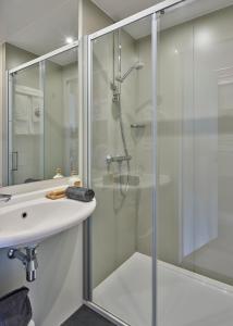 a bathroom with a shower and a sink at Holiday Suites Jabbeke - Klein Strand in Jabbeke