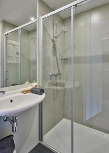 a bathroom with a shower and a sink at Holiday Suites Jabbeke in Jabbeke