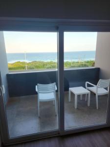 a room with a view of the ocean from a window at 12 Oceans Hotel and Conference Centre in Kingsburgh