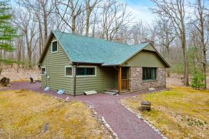 a small green house in the middle of a yard at Woodland Cabin Retreat in Lake Harmony