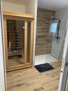 a bathroom with a shower and a sink in a room at Escapade Normande avec son sauna privé in Le Tourneur +20 photos