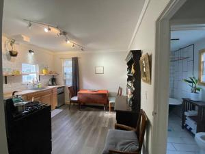 a living room with a kitchen and a dining room at Studio Apt w Garden in Kingston