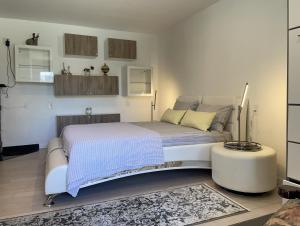 a bedroom with a bed and a table in it at One bedroom with modern kitchen, balcony with water view in Greenwich