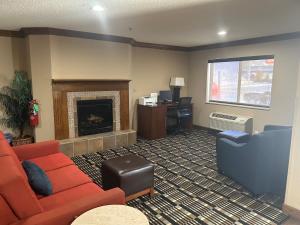 a living room with a couch and a fireplace at Quality Inn & Suites Bradford in Bradford