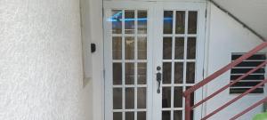 a door to a house with a staircase next to it at More Than Beauty Properties in Tortola Island