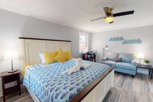 a bedroom with a bed with a dog laying on it at 805 - Friendly Native Beach Resort in St. Pete Beach