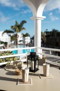 a table with a tray of food and cups on a balcony at Sotavento Beach Club in Costa Calma