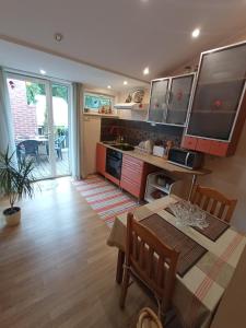 a kitchen with a table and a dining room at Jurmala's Centre Apartments in Jūrmala