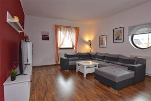 a living room with a couch and a table at Ferienwohnung Schmalkalden am Radwanderweg in Schmalkalden
