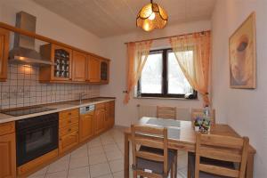 a kitchen with a table and a dining room at Ferienwohnung Schmalkalden am Radwanderweg in Schmalkalden