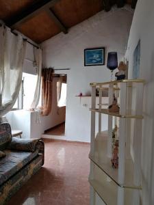 a living room with a couch and shelves with dolls at House Rural,Biosphere Reserve World.Taganana.Tfe. in Santa Cruz de Tenerife