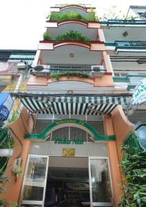 a building with an awning in front of a store at Thao Nhi Hotel in Ho Chi Minh City