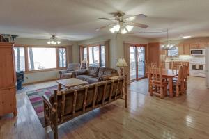 a living room with a couch and a table at Dog Friendly Leech Lake Home w Perfect Beach Garage Boat Lift in Walker