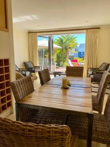 a wooden table and chairs with a view of the ocean at 42 Spinnaker, The Quays in Knysna