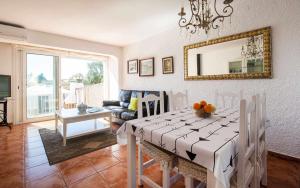 a dining room with a table and a mirror at Casa Angels Tossa de Mar parking y wifi in Tossa de Mar