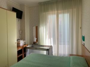 Ліжко або ліжка в номері Pensione TOSCA B&B Cattolica