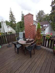 a patio with a table and chairs on a deck at Jurmala's Centre Apartments in Jūrmala