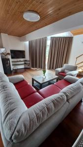 a living room with a large couch and a table at Villa Haškova with 3 bedrooms in Banská Bystrica