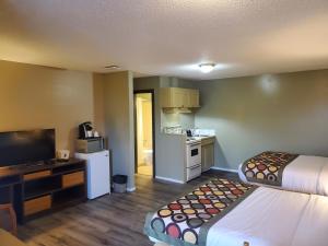 a hotel room with two beds and a kitchen at Super 8 by Wyndham Duncan in Duncan