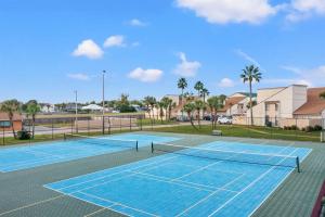 a tennis court with a net on it at Chic Townhouse Steps to the Beach Outdoor Pools in Panama City Beach