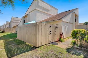 a wooden fence in front of a house at Chic Townhouse Steps to the Beach Outdoor Pools in Panama City Beach
