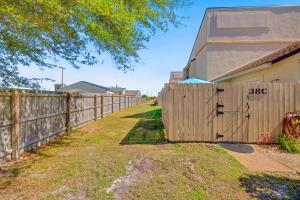 a wooden fence in front of a house at Chic Townhouse Steps to the Beach Outdoor Pools in Panama City Beach