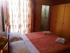 a bedroom with a bed with two towels on it at Hotel Simon in Rimini