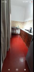 a red floor in a kitchen with a sink at Mi Buen Relax in Puerto Iguazú