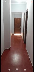 an empty hallway with a wooden door in a building at Mi Buen Relax in Puerto Iguazú
