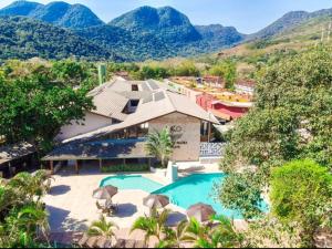 an aerial view of a house with a swimming pool at Porto Paúba Flat 116 in Pauba