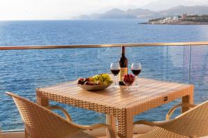 uma mesa com uma taça de fruta e dois copos de vinho em DreamSea Apartment em Utjeha
