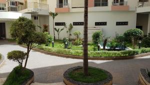 a courtyard with two trees and a building at Deluxe apartments in Casablanca