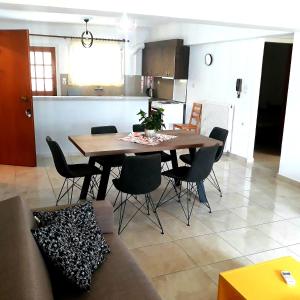 a dining room and kitchen with a table and chairs at InStyle Zakynthos town Apartment in Zakynthos
