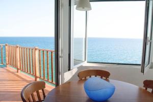 a dining room with a table and a view of the ocean at Apartamento en acantilado con wifi y aire acondicionado in Sitges +38 photos