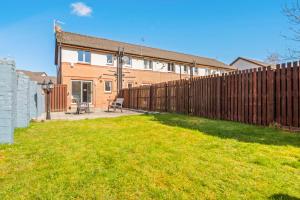 a wooden fence in front of a house at I'm Your Host - Bridgeton House in Glasgow