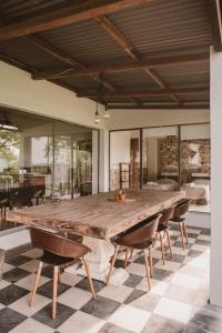 a large wooden table in a room with chairs at El Rincón. Farm and Lodge in Carmelo