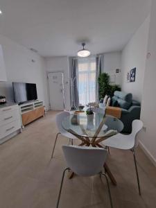 a living room with a glass table and chairs at Urban suite 1 in Málaga