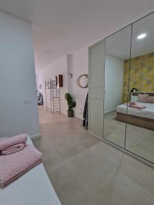 a bedroom with a glass walled shower and a bed at Urban suite 1 in Málaga
