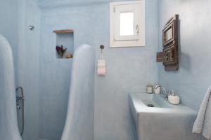 a bathroom with a shower and a sink and a tub at Villa Fani Kythnos in Kithnos +60 photos