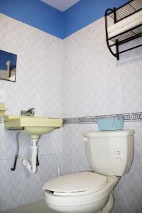 a bathroom with a toilet and a sink at Casa Santiago in Oaxaca City