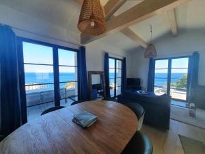 a living room with a wooden table and a couch at VILLA ELBA in Brando