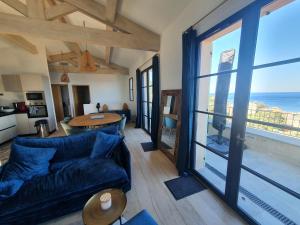 a living room with a couch and a view of the ocean at VILLA ELBA in Brando
